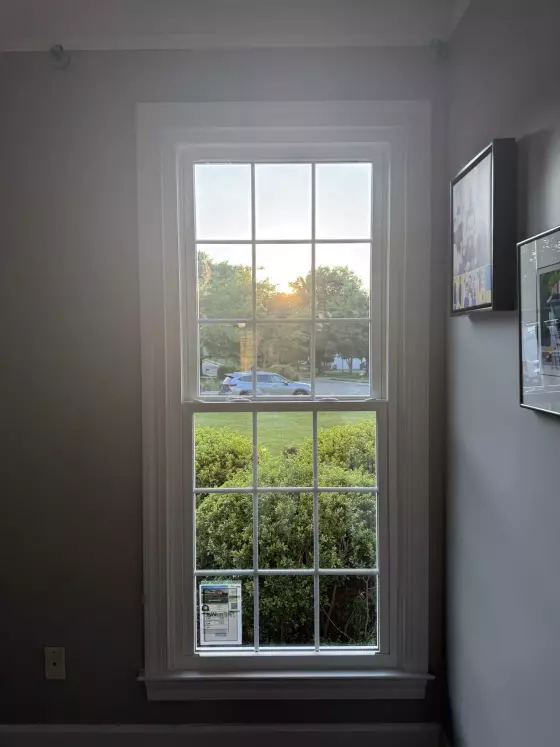 Single window with trim and glass viewed from inside a room