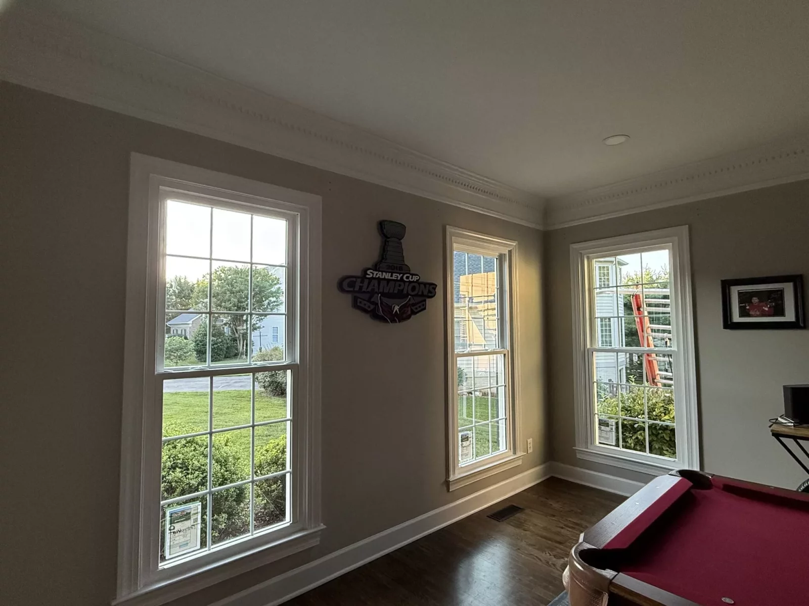 Three double-hung windows with white trim in a residential room
