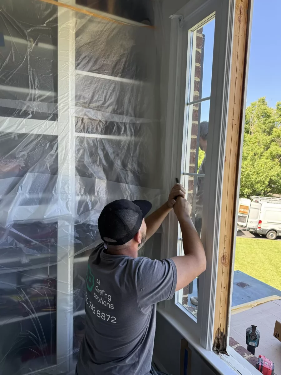 Window replacement in progress in Rockville, MD, showing professional removal and installation of a new energy-efficient window.