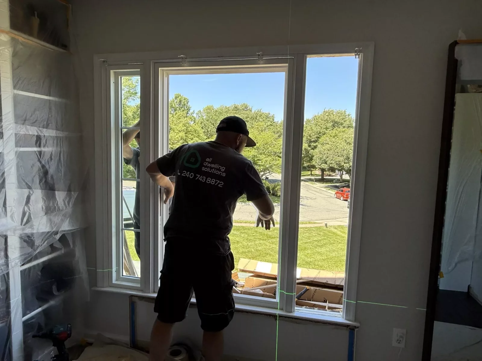 Professional window installation in progress in Rockville, MD, with laser leveling for precise alignment and performance.