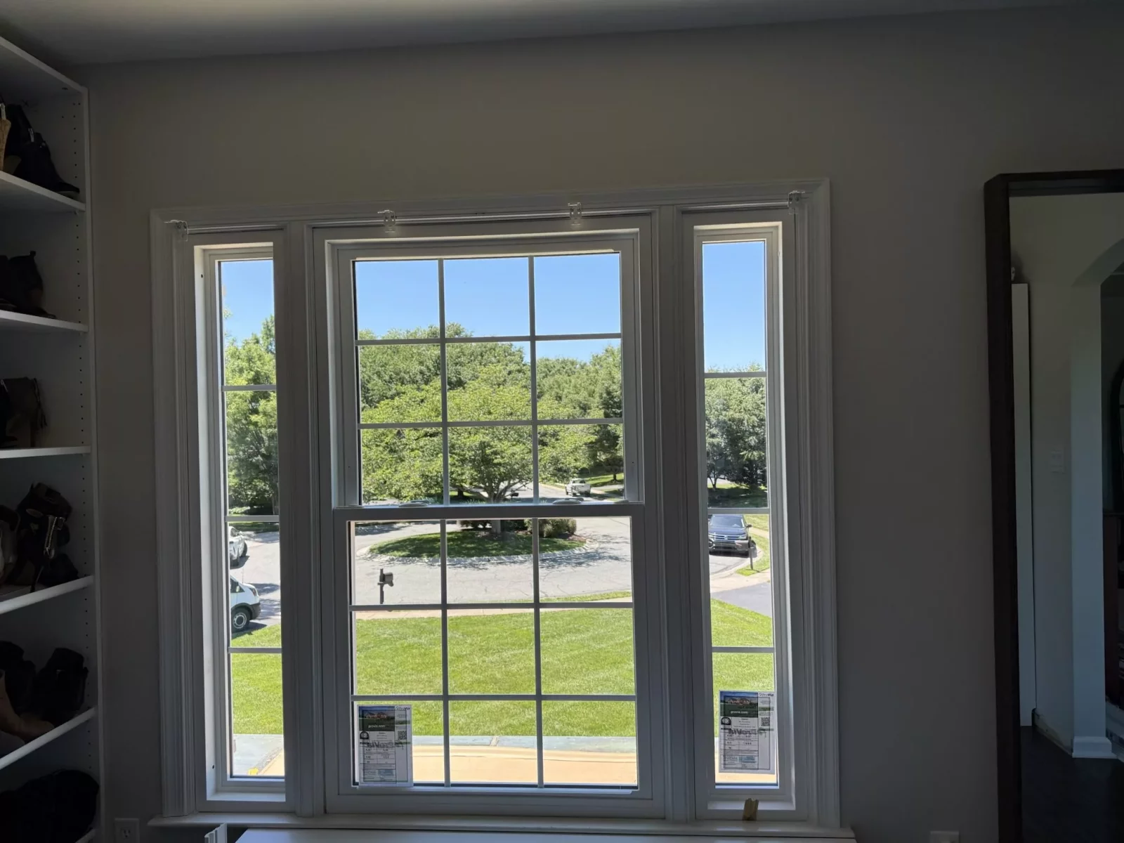 Completed energy-efficient window replacement in Rockville, MD, featuring a new double-hung window with sidelites and grids.