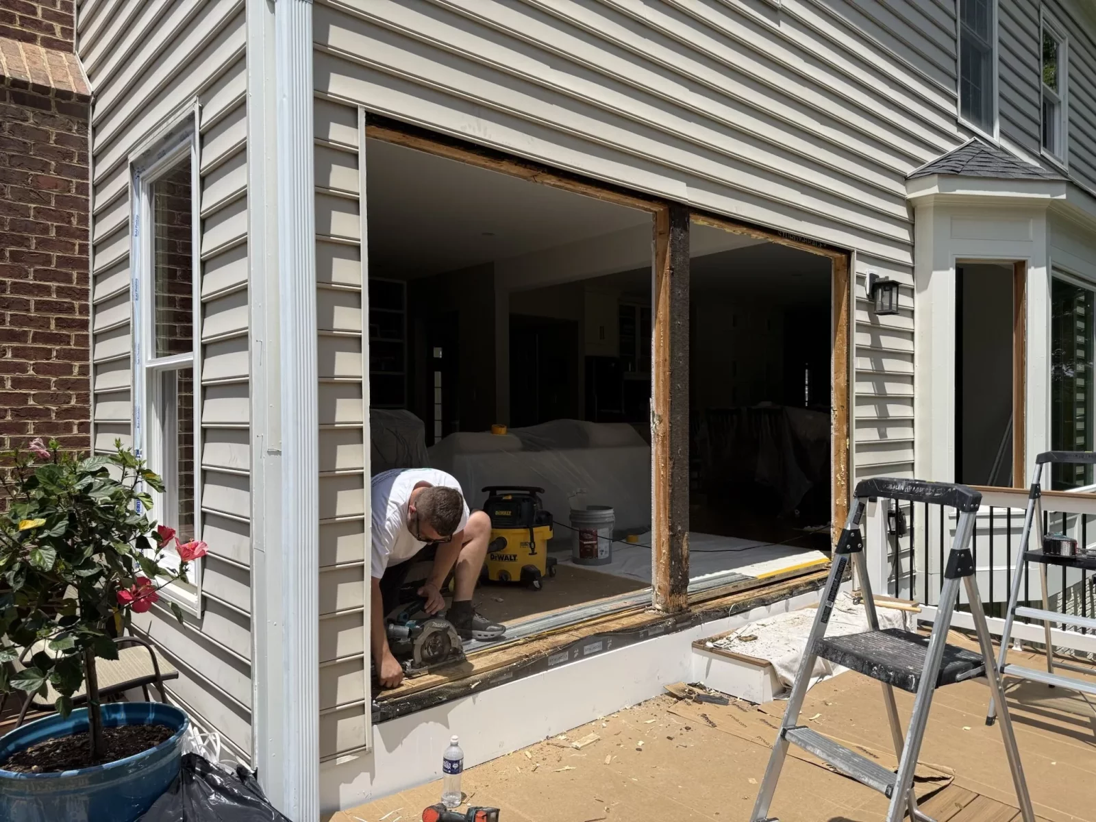 Full-frame patio door replacement in Rockville, MD, showing removal of old doors and preparation of the openings for installation.