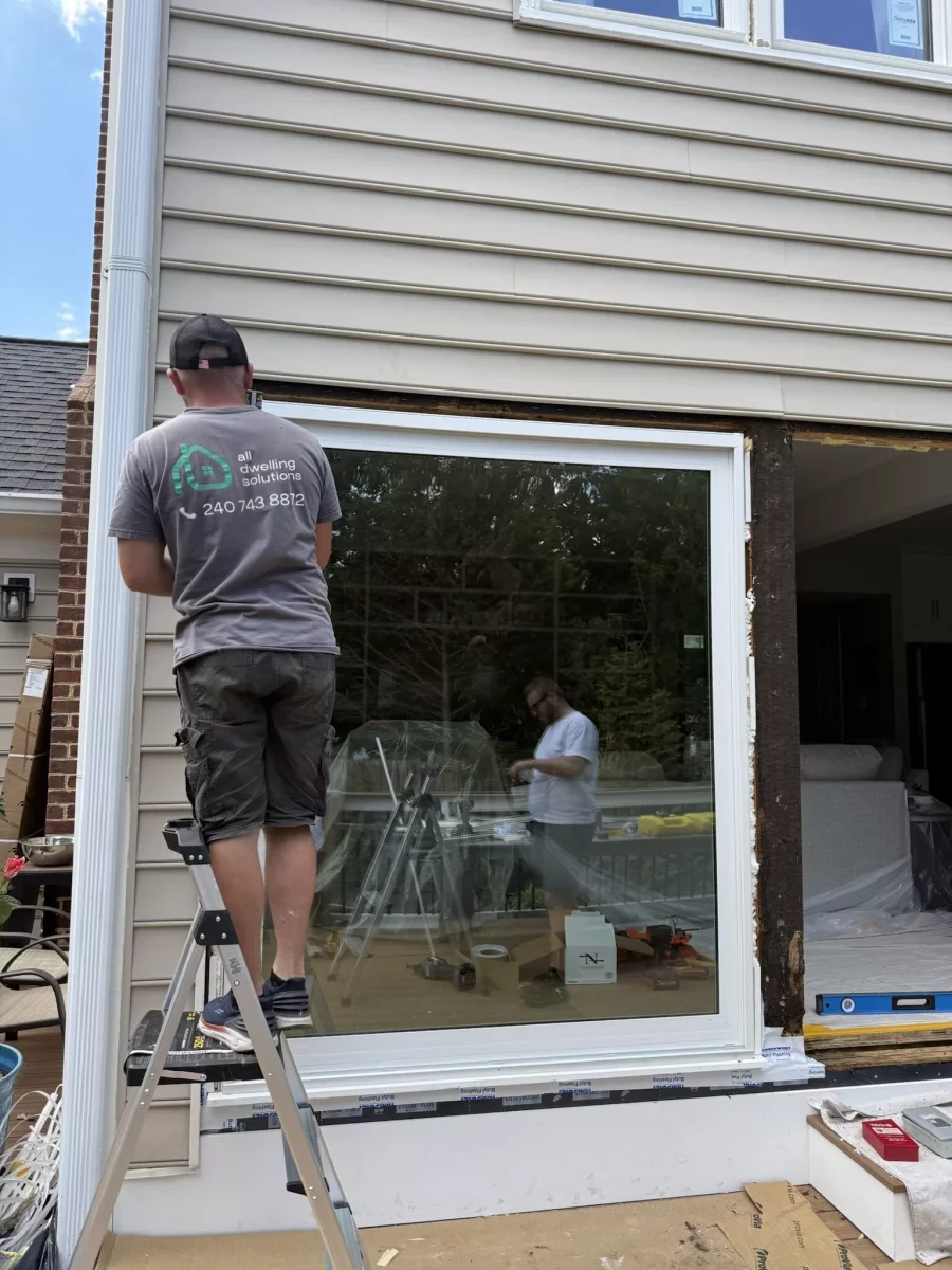 Professional patio door installation in Rockville, MD, showing a new energy-efficient sliding glass door during full-frame replacement.