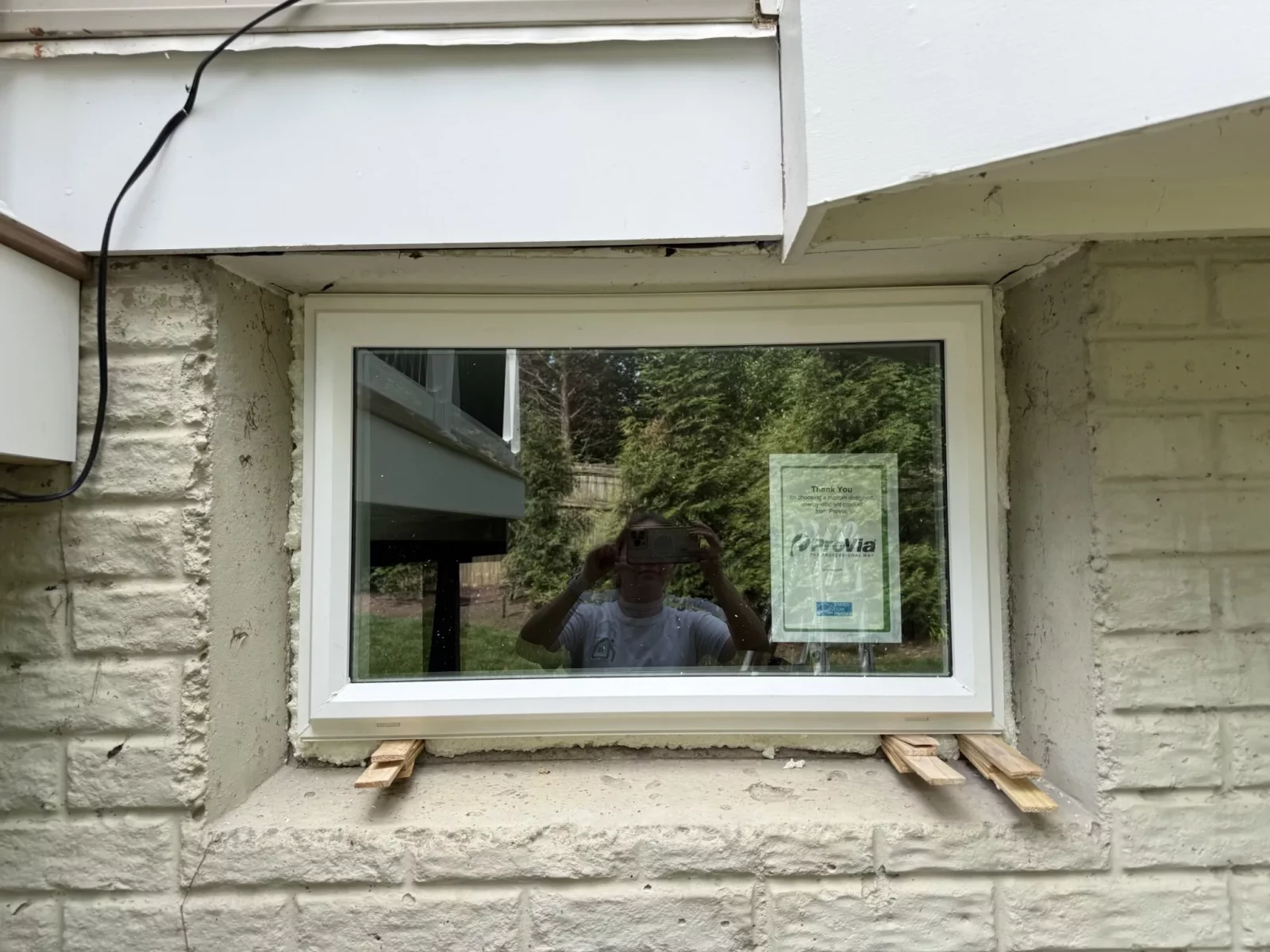 Energy-efficient basement window replacement with a new custom-fit vinyl window installed in a masonry opening in Rockville, MD.