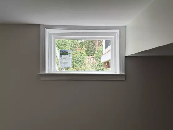 Energy-efficient basement window replacement in Rockville, MD, with clean interior trim and professional full-frame installation.