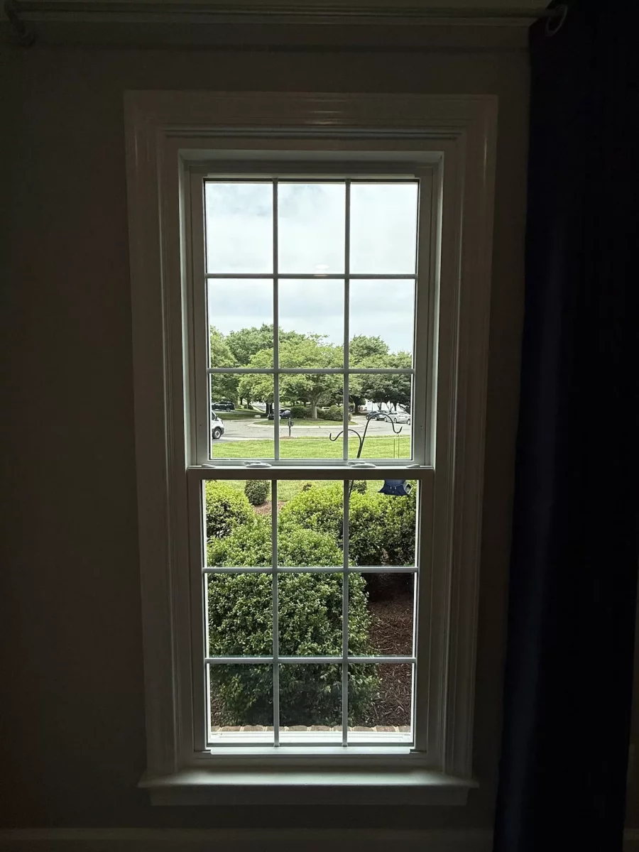 Energy-efficient double-hung window replacement in Rockville, MD, with grids and professionally finished interior trim.