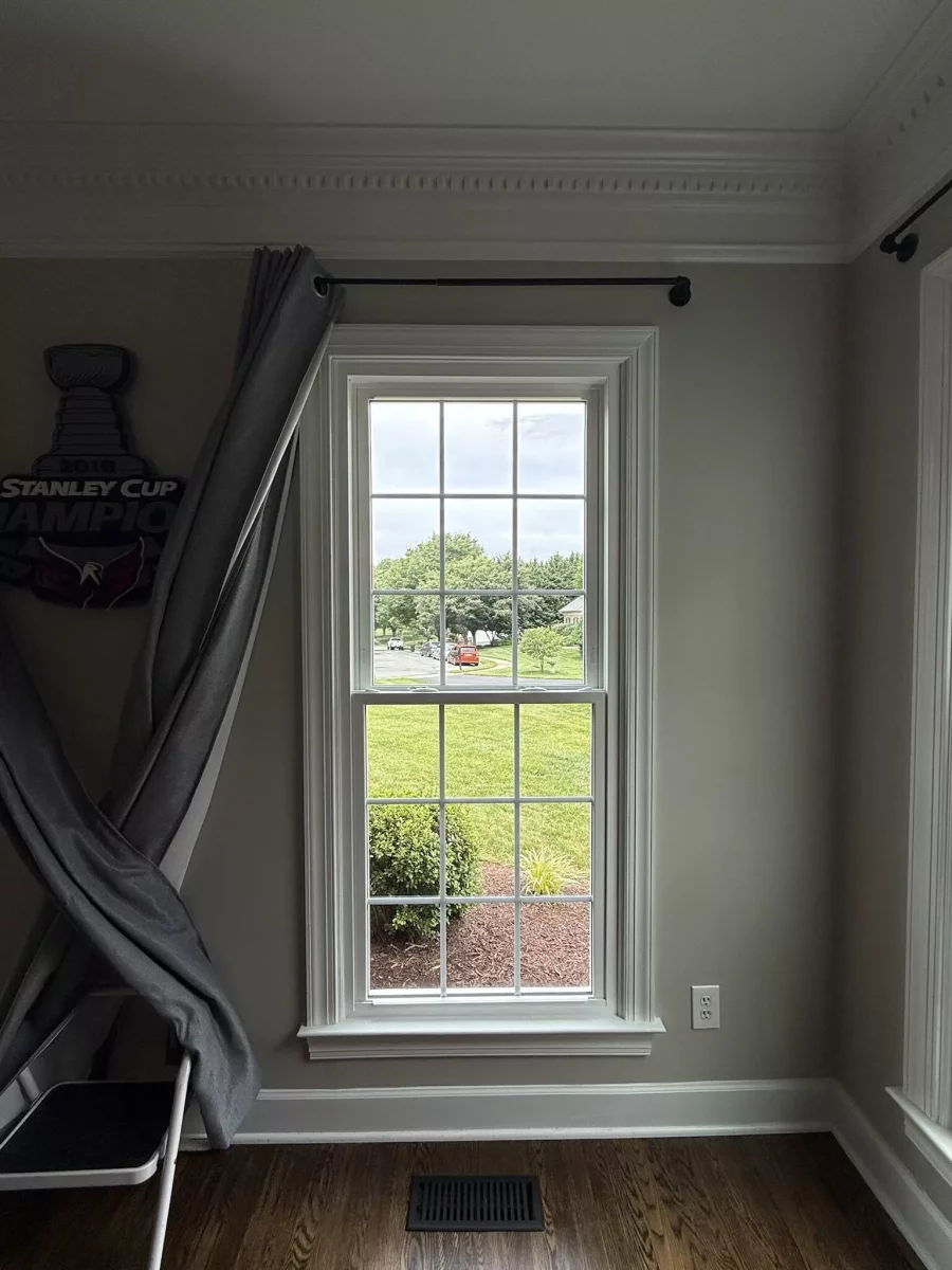 Energy-efficient double-hung window replacement in Rockville, MD, with grids and professionally finished interior trim.