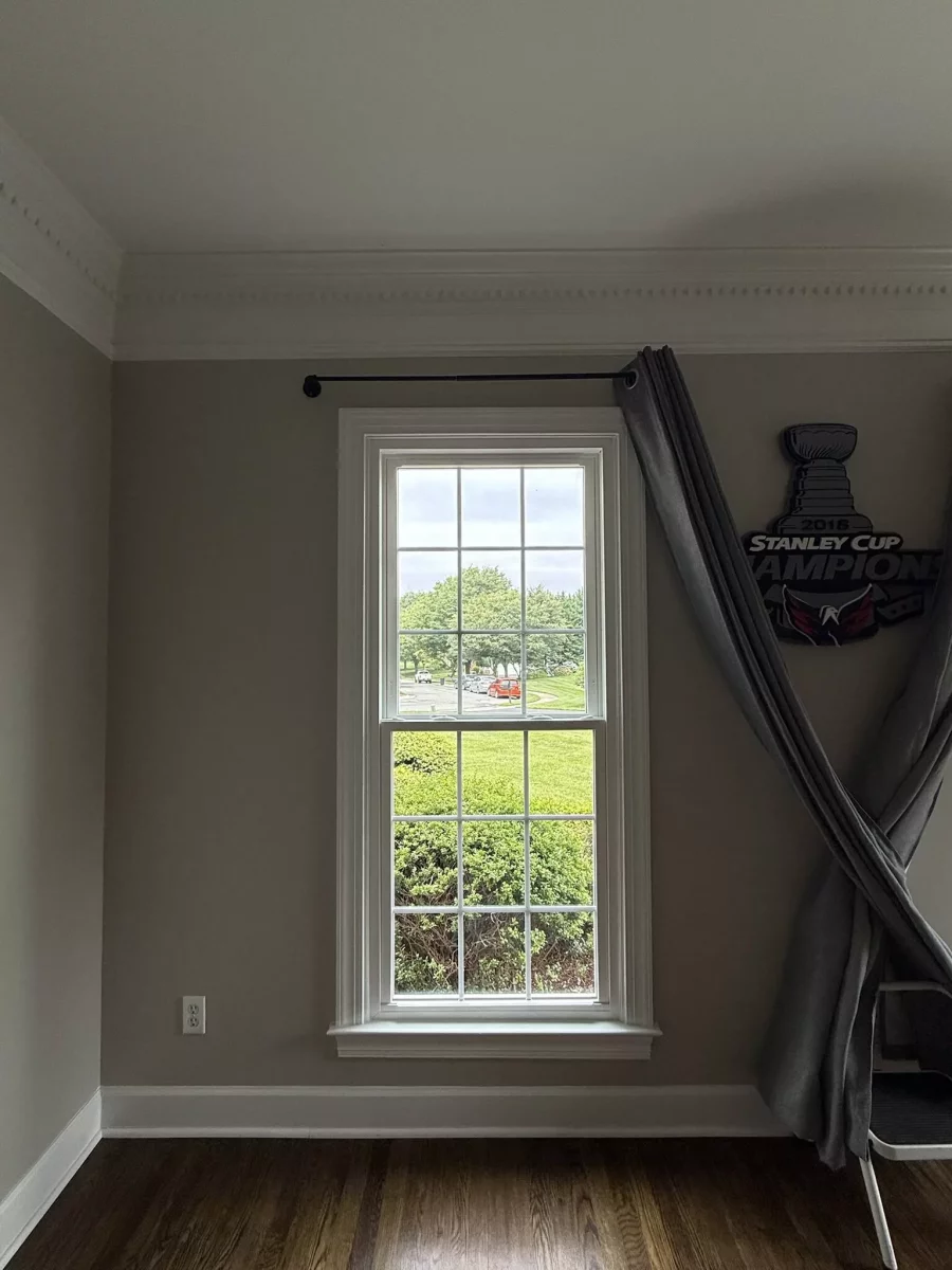 Energy-efficient double-hung window replacement in Rockville, MD, with grids and professionally finished interior trim.