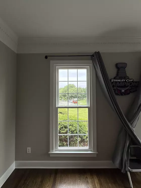 Energy-efficient double-hung window replacement in Rockville, MD, with grids and professionally finished interior trim.