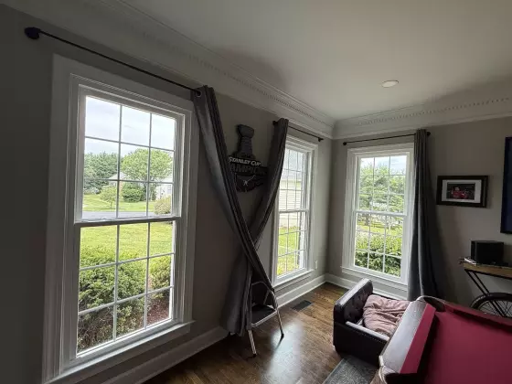 Three double-hung windows with white trim in a residential room