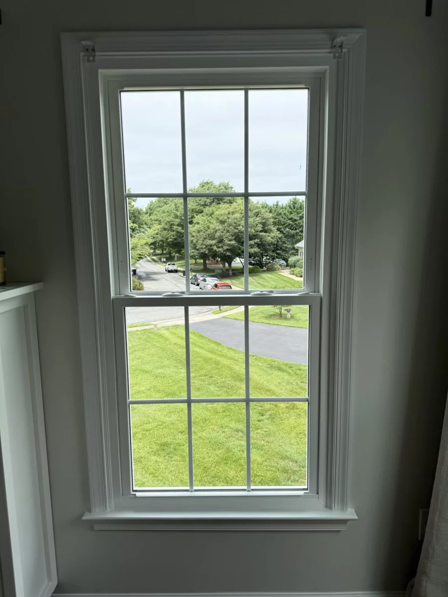 Energy-efficient double-hung window replacement in Rockville, MD, with grids and professionally finished interior trim.