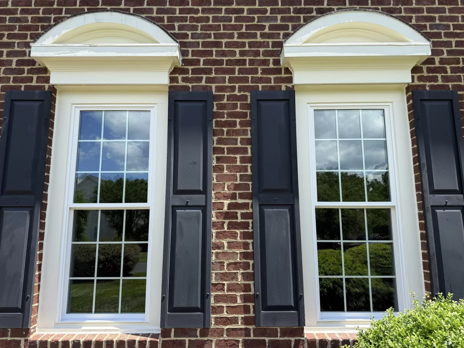 Energy-efficient double-hung window installed with colonial grids on a brick home in Rockville, MD