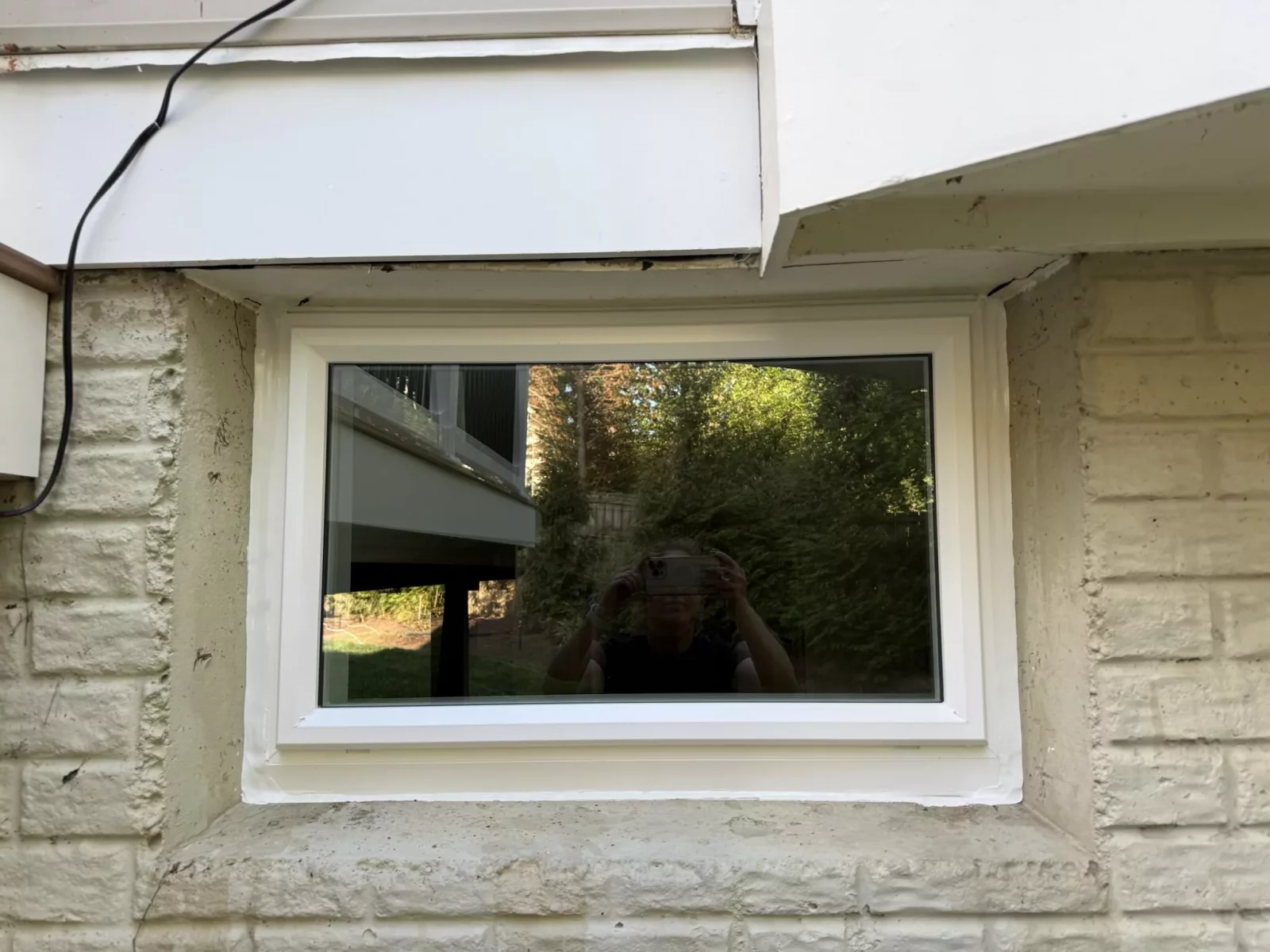 Energy-efficient basement picture window replacement with clean white trim in Rockville, MD.
