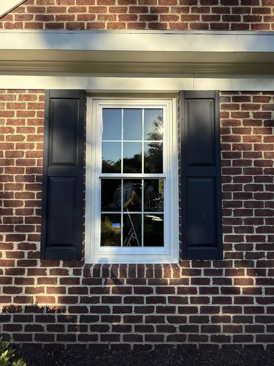Full-frame double-hung window replacement with colonial grids on a brick home in Rockville, MD.