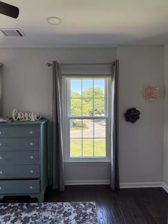 Energy-efficient double-hung window replacement in Rockville, MD, with grids and professionally finished interior trim.