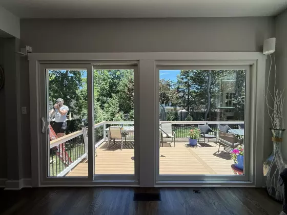 Completed patio door and large picture window replacement with clean interior trim in Rockville, MD.