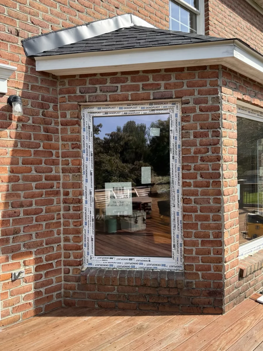 New window with protective film installed in brick exterior wall