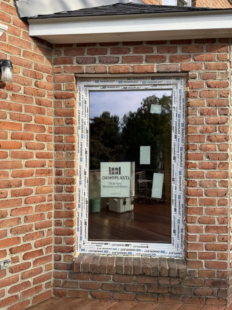 New window with protective film installed in brick exterior wall