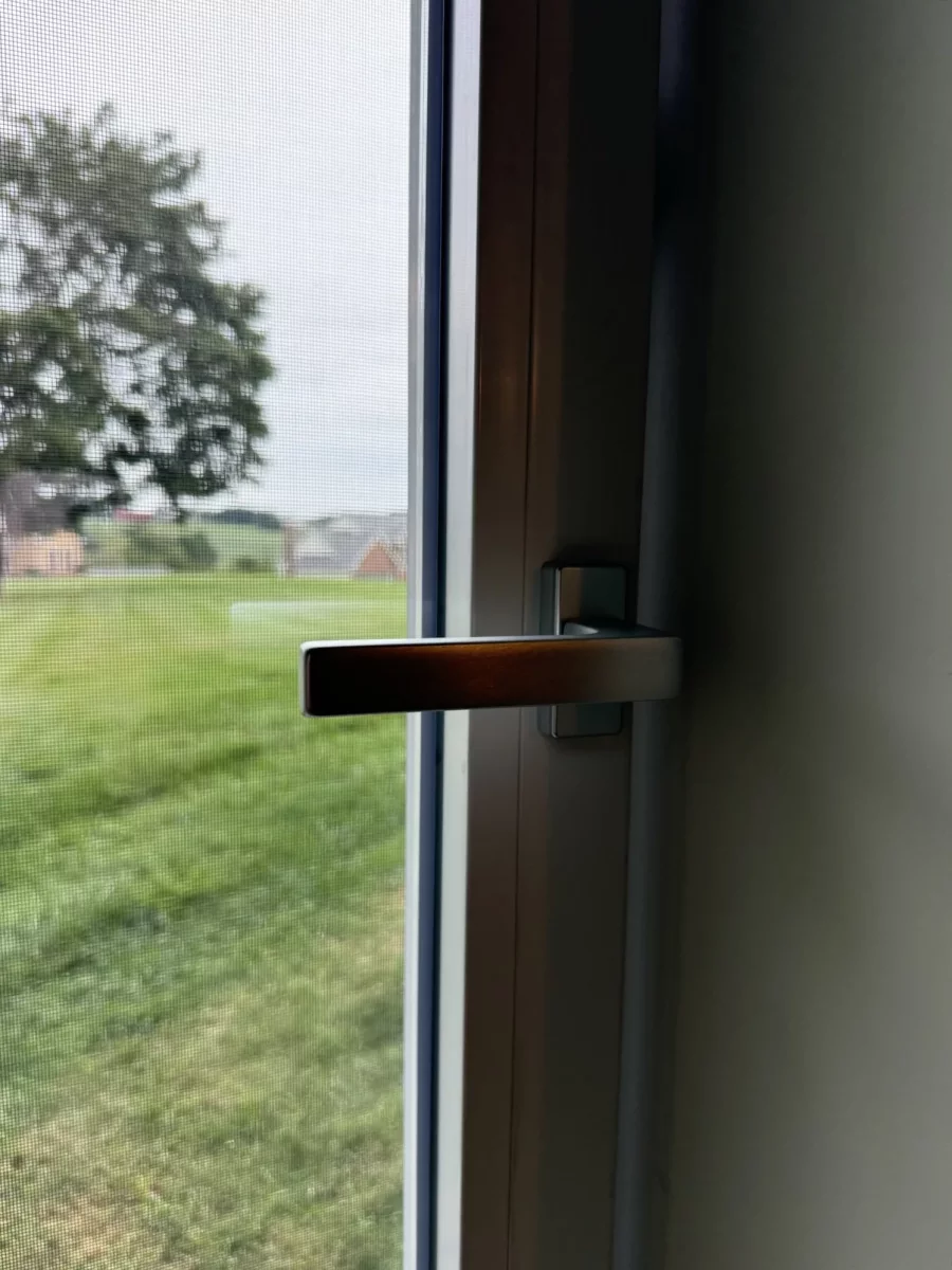 Close-up of window handle and screen from interior
