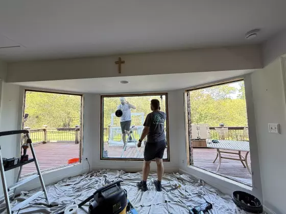 Full-frame Oknoplast window replacement in progress with multiple old windows removed in Monrovia, Maryland