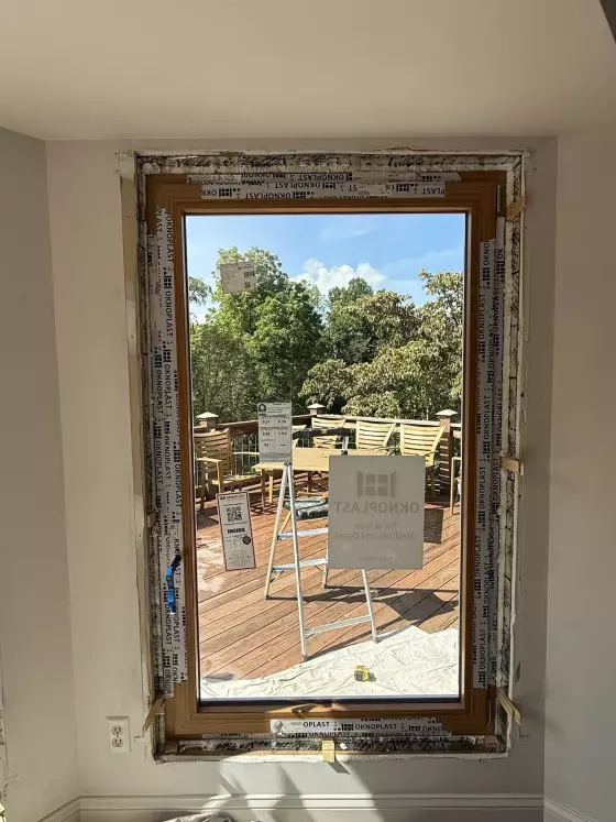 Window installation in progress with protective film and tools visible