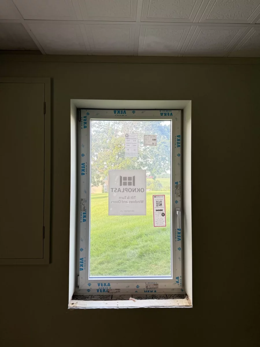 New window with protective film installed in interior wall
