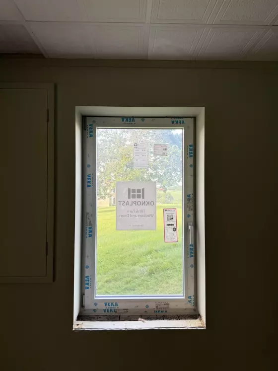 New window with protective film installed in interior wall