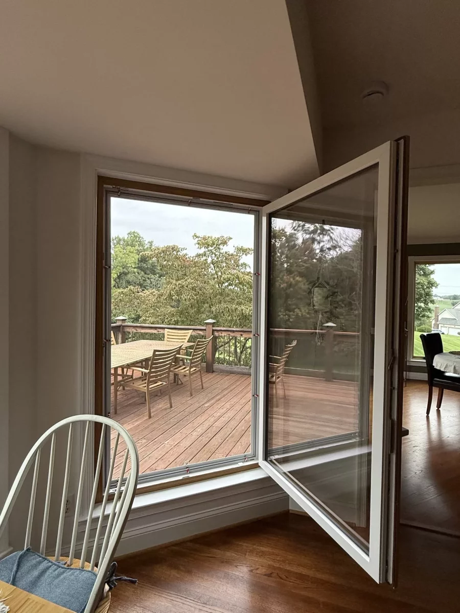 Open tilt and turn window overlooking wooden deck