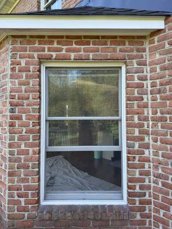 Before Oknoplast tilt-and-turn window replacement at a brick home in Monrovia, Maryland