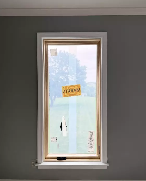 New Marvin Elevate window installed with full-frame replacement and natural wood interior finish.