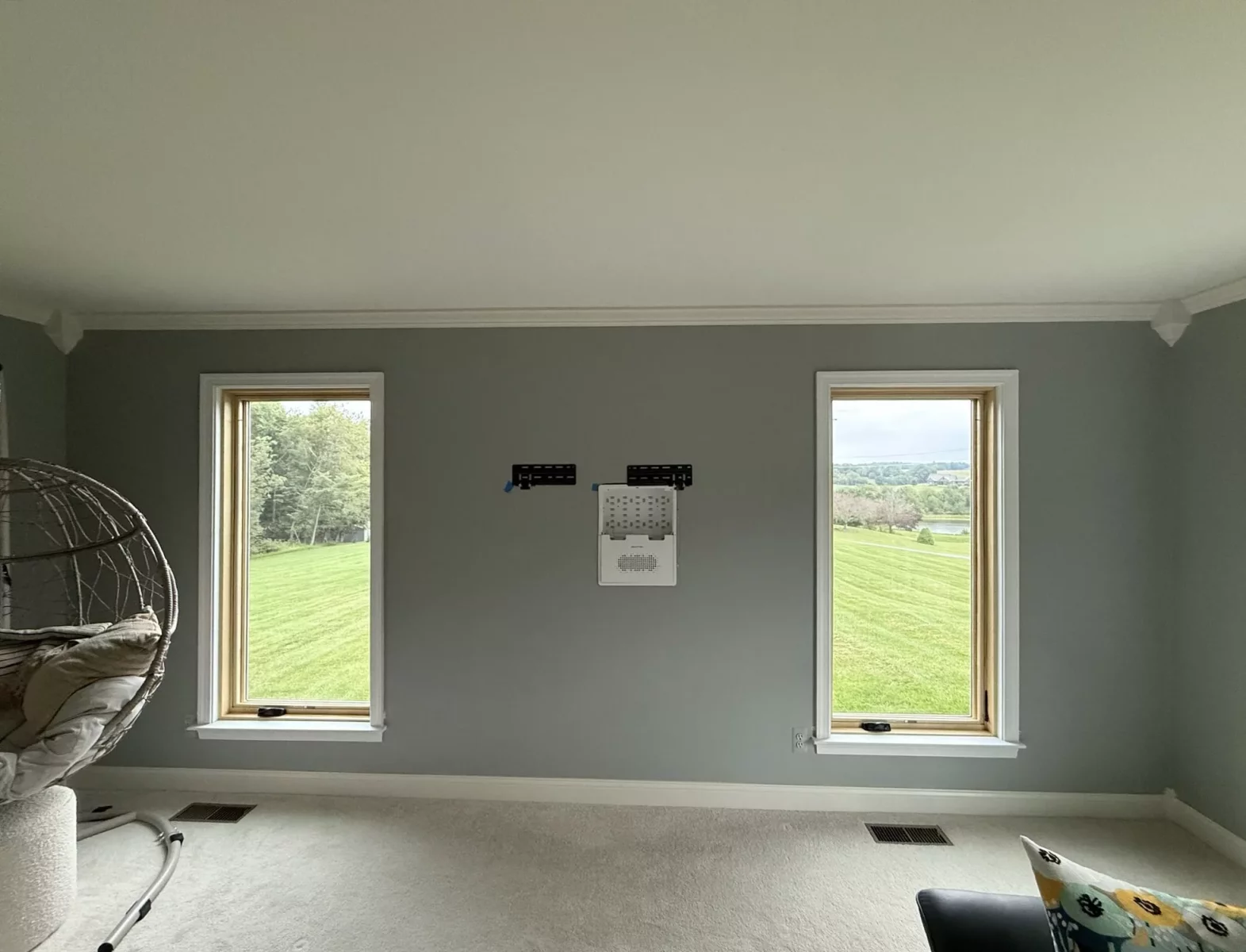 Completed Marvin Elevate full-frame window replacement with natural wood interiors and clear views from the living room.