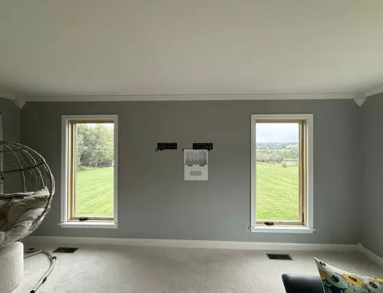 Completed Marvin Elevate full-frame window replacement with natural wood interiors and clear views from the living room.