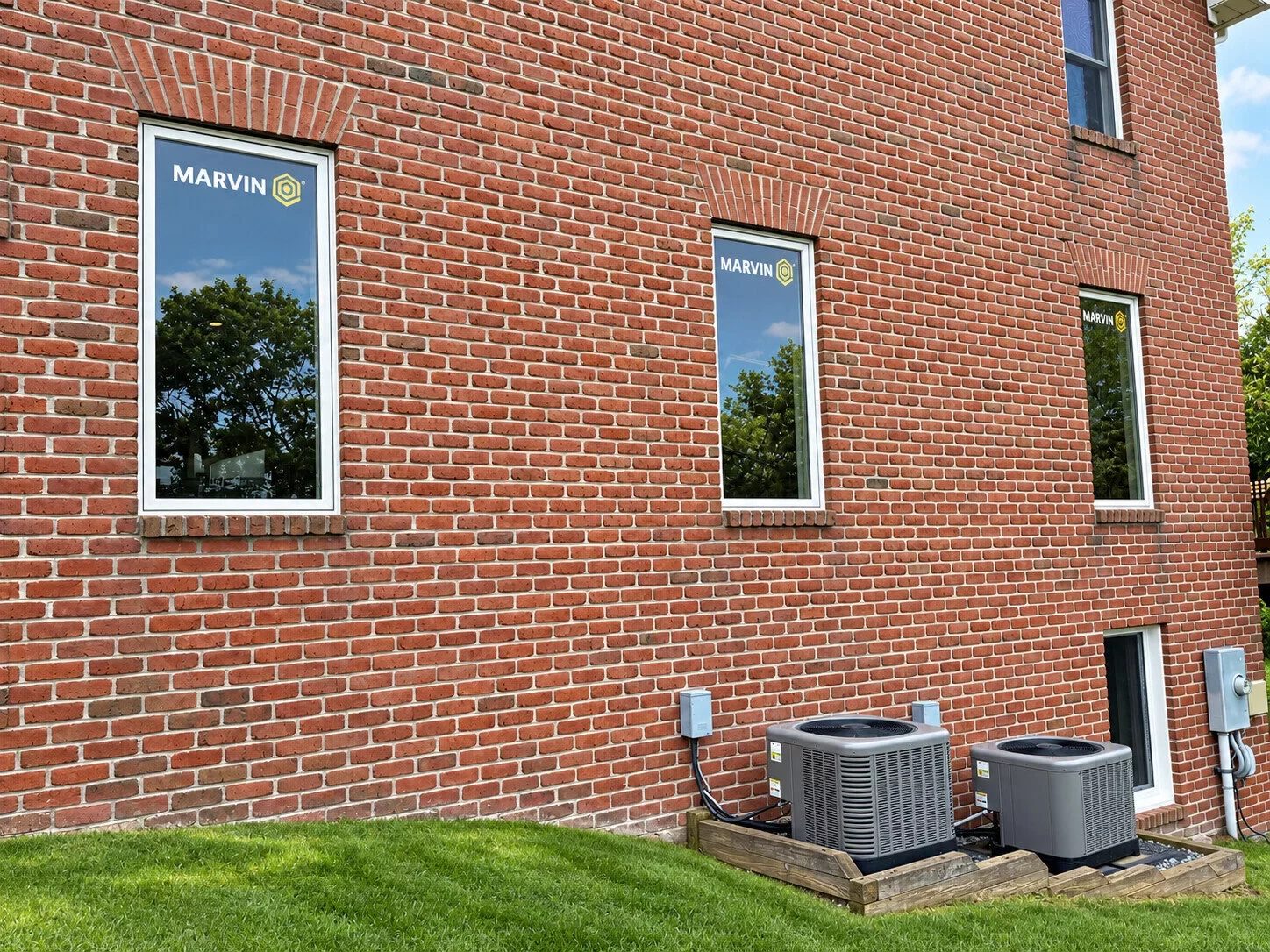 Completed Marvin Elevate full-frame window installation with fiberglass exteriors on a brick home in Monrovia, Maryland.