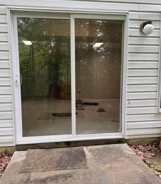 Completed sliding patio door glass replacement in Aspen Hill, MD, with new tempered glass installed in the existing door sash.