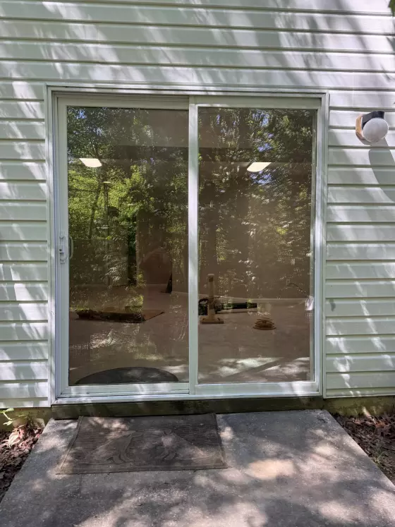 Completed sliding patio door glass replacement in Aspen Hill, MD, with new tempered glass installed in the existing door sash.