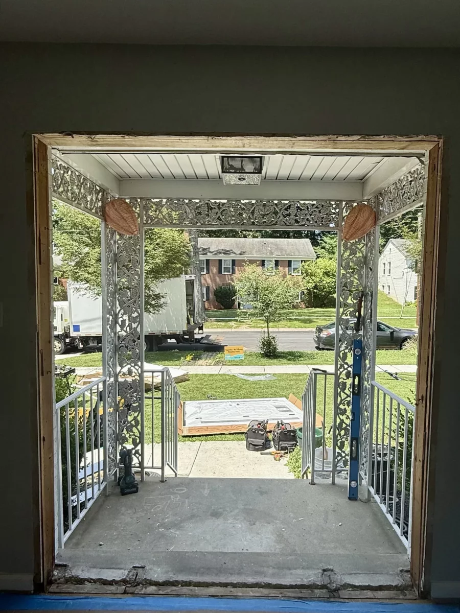 Entry door opening with tools and materials visible during installation