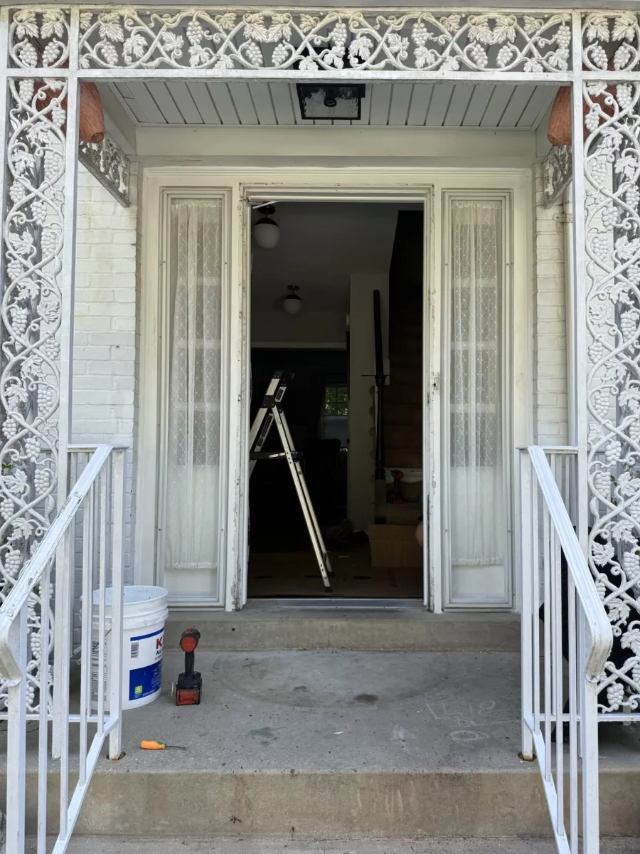 Old front door removed, original sidelites still in place, during ProVia entry door replacement in Rockville, MD