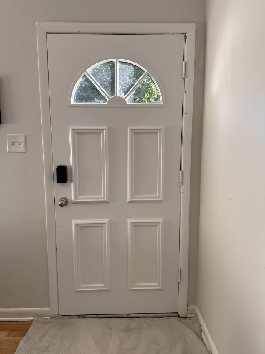 Interior view of old entry door  with foggy glass before front door replacement in Olney, MD