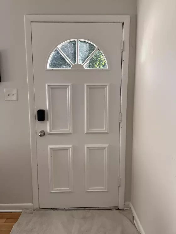 Interior view of old entry door  with foggy glass before front door replacement in Olney, MD
