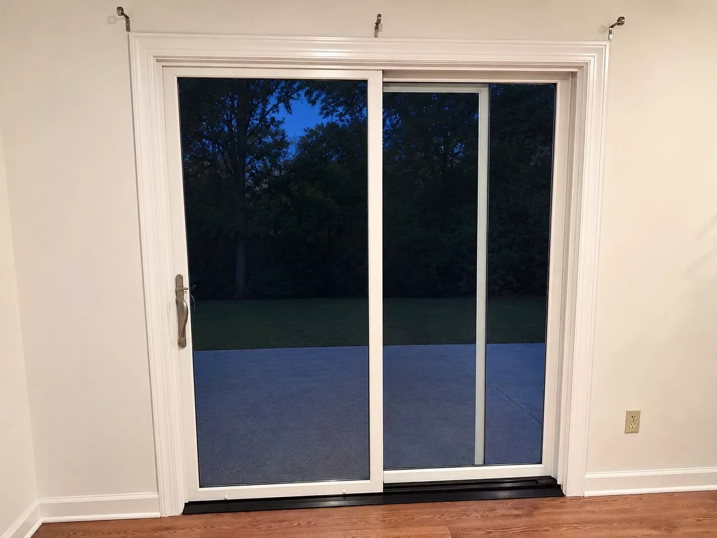 Interior view of new white Marvin Elevate sliding patio door with painted trim and casing in Glenwood, MD