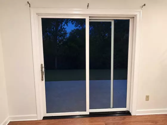 Interior view of new white Marvin Elevate sliding patio door with painted trim and casing in Glenwood, MD