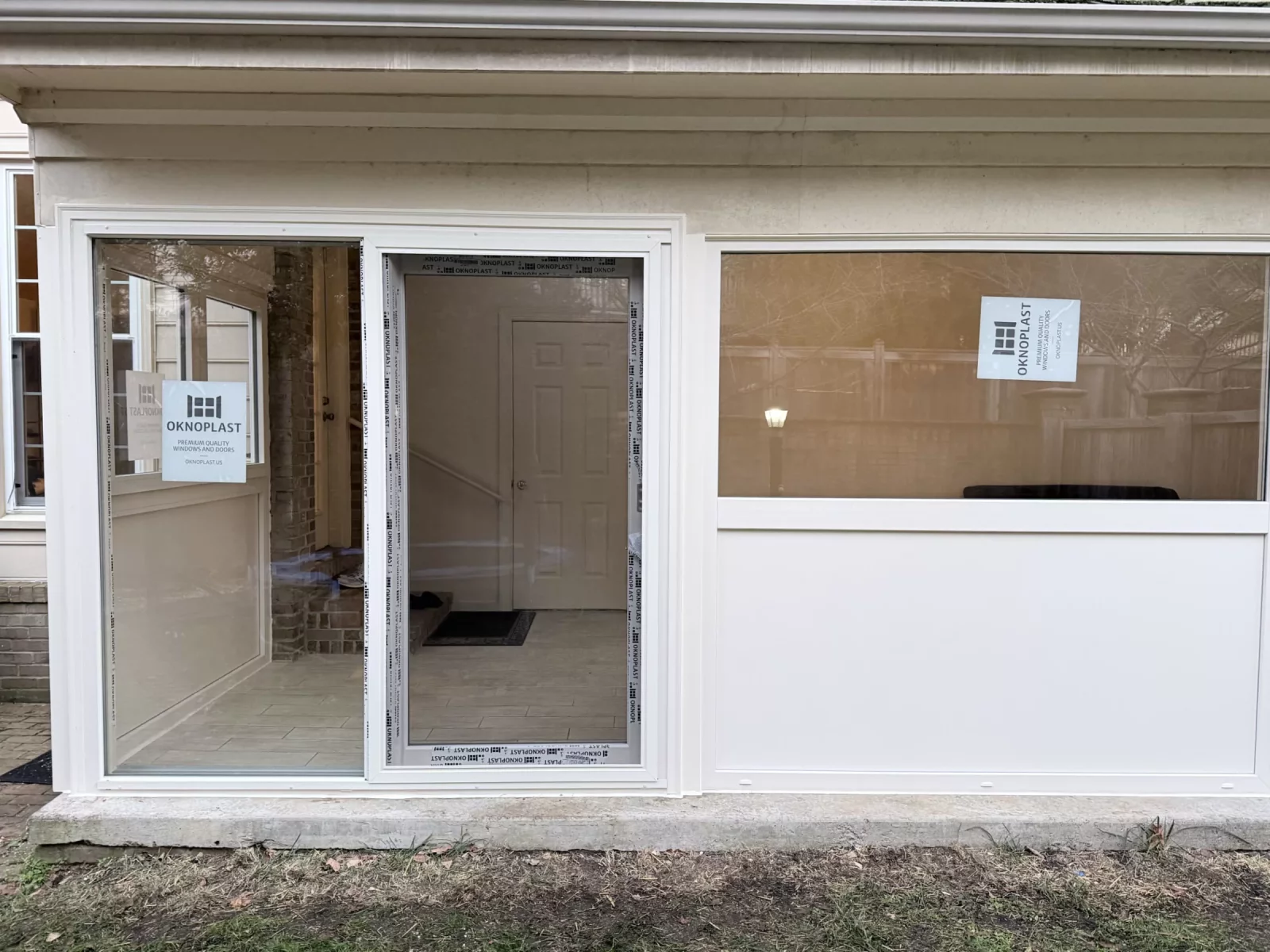 Close-up of Oknoplast Compact sliding patio door and picture window with insulated panel on a Potomac, MD sunroom