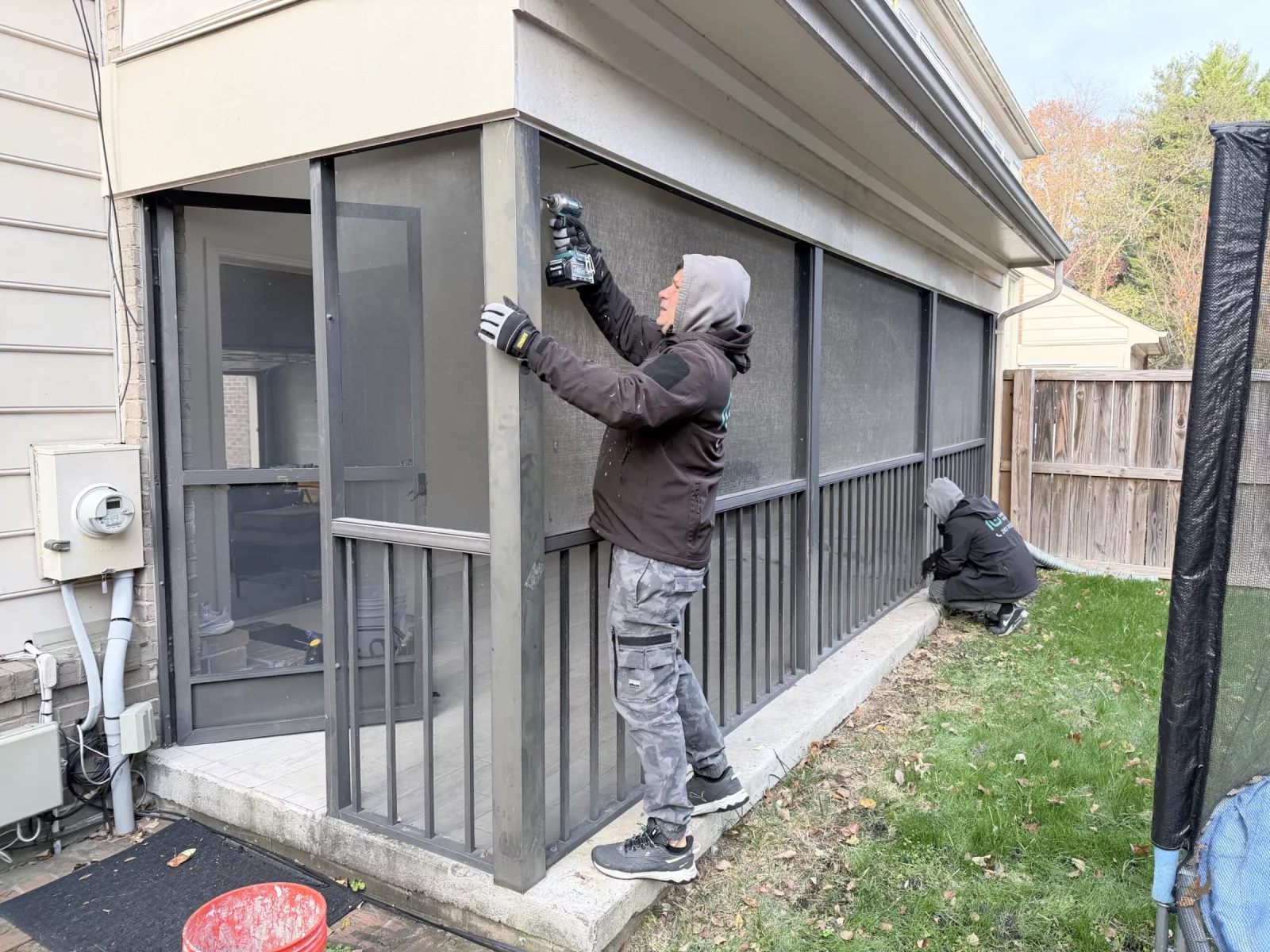 All Dwelling Solutions crew removing old screened porch framing before Oknoplast sunroom conversion in Potomac, MD