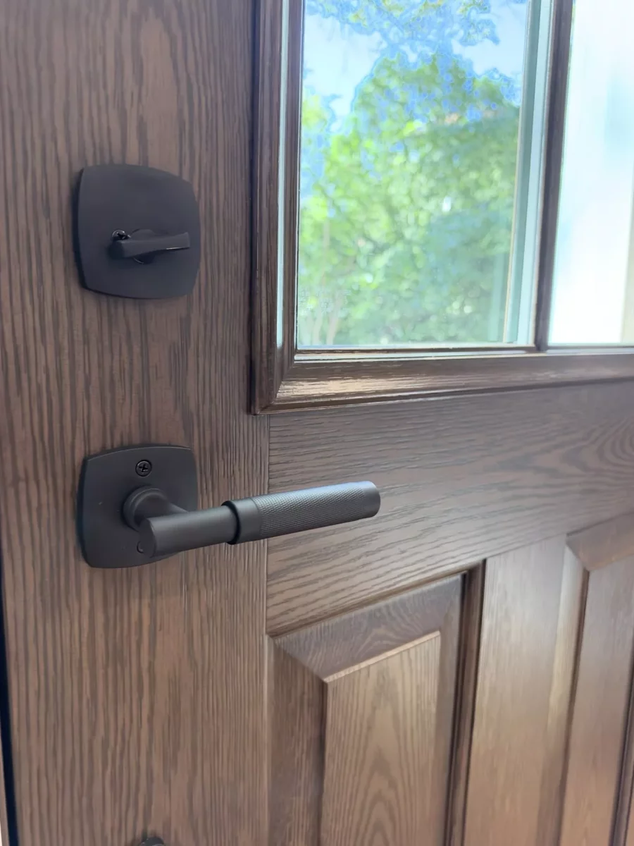 Close up of a wooden entry door with handle and lock