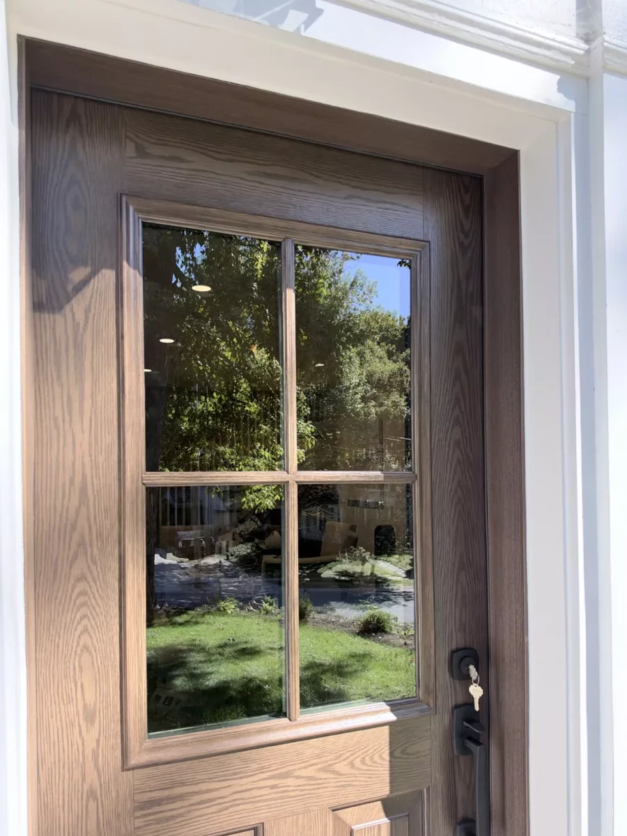 Wood entry door with glass panels and black handle