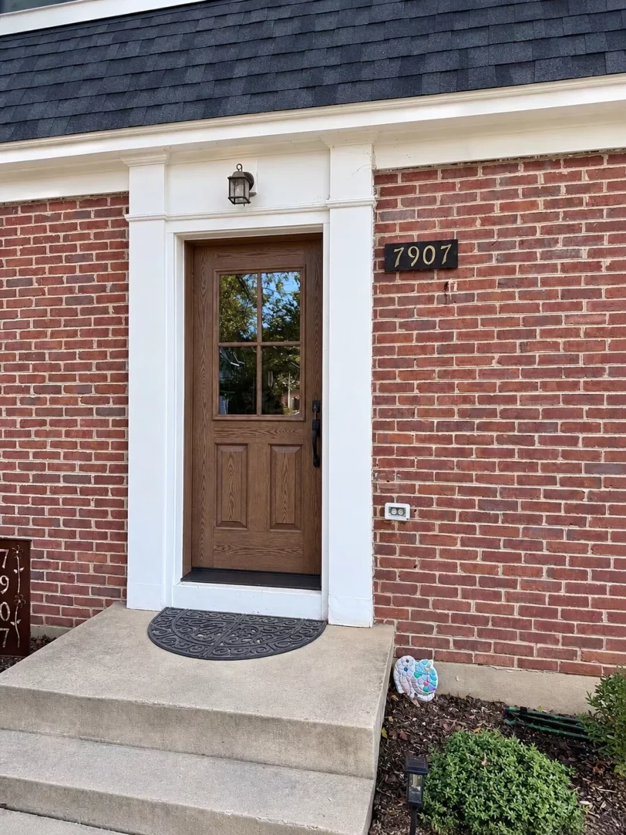 Fiberglass front door with wood-grain finish and 4-lite glass on a brick colonial home in Bethesda, MD