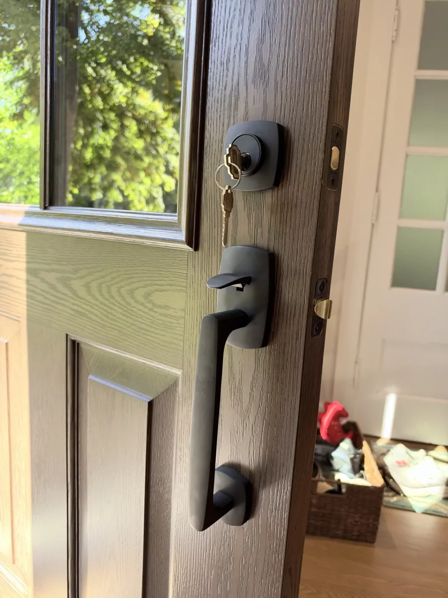 Close-up of a residential entry door with handle and lock installed