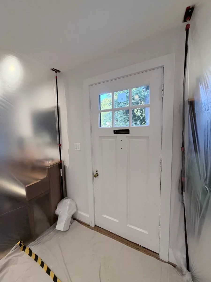 Entry door area with protective film and floor covering during installation