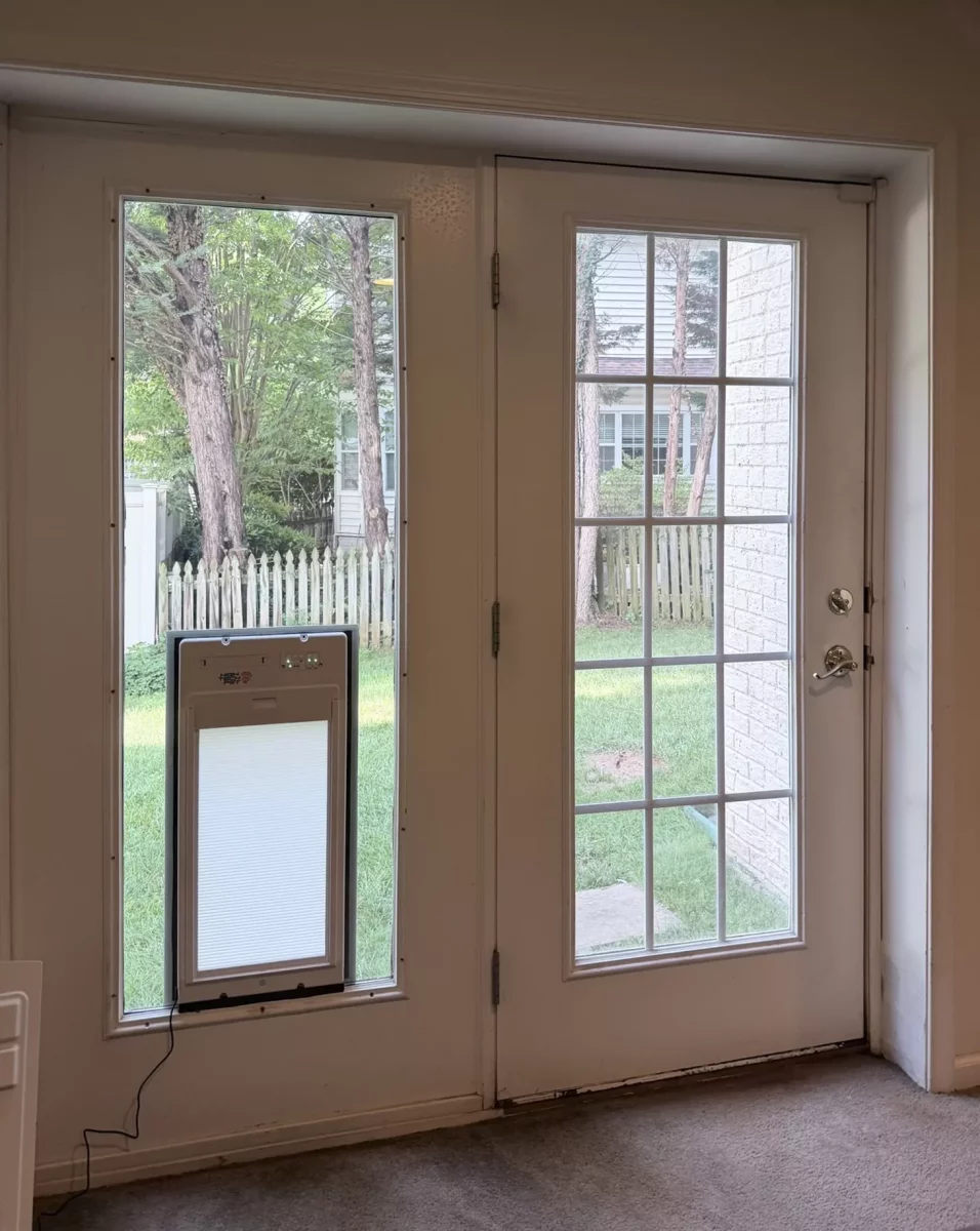 Interior view of a glass door with a pet door installed