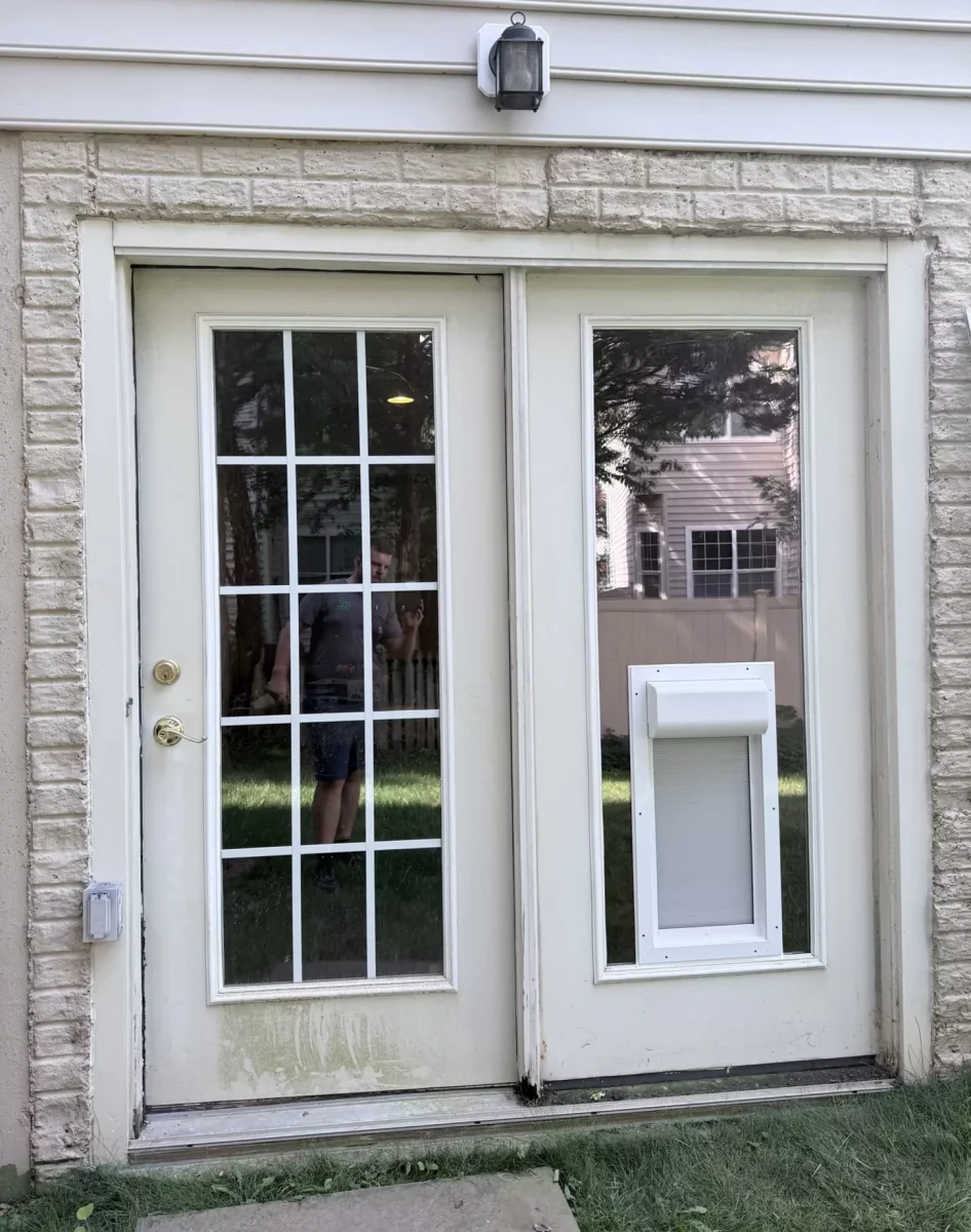 Exterior view of a door with a newly installed pet door